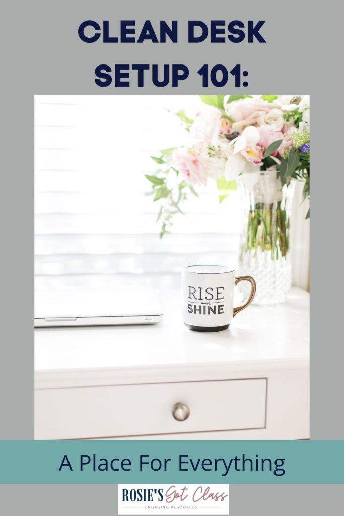 Clean desk with a computer, a coffee cup that says rise and shine, and a vase of flowers on a white desk in front of a window that says clean desk setup 101 - a place for everything