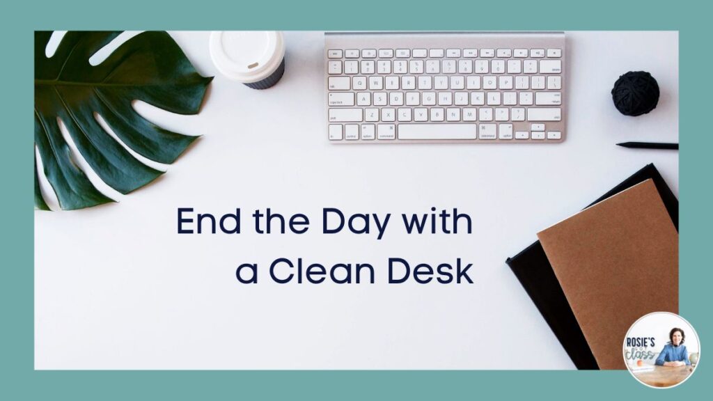 Part of palm leaf, pencil, a black and brown notebook, a keyboard, a ball of black yarn, and a disposable coffee cup that says end the day with a clean desk