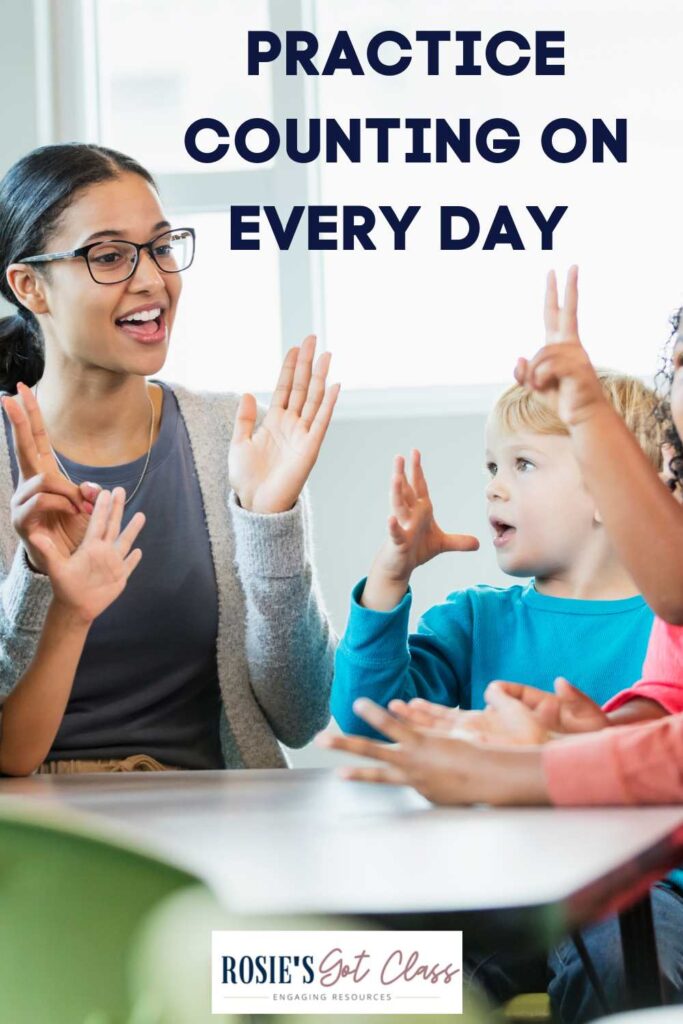 teacher helping students sitting at a table to practice the counting on addition strategy