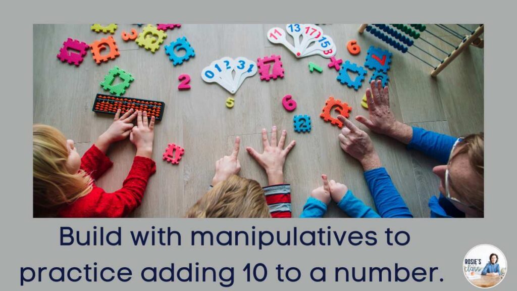 3 children on the floor with a teacher using math manipulatives to add 10 to a number.