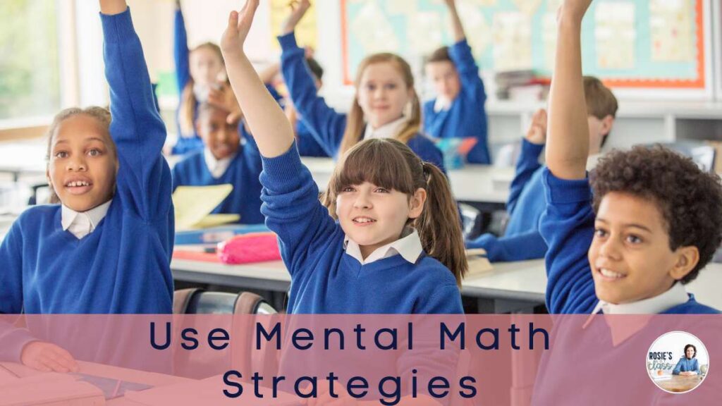 children in a classroom raising their hands to answer a math question after using mental math strategies